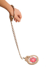 Women`s hand in candcuffs and condom