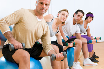 Exercising with fitness ball at gym