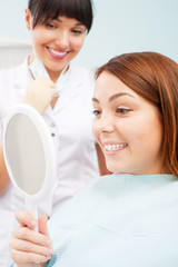 woman looking at her beautiful teeth