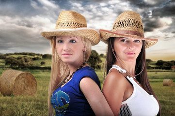 Two Girls Wearing cowboy Hats And Smiling