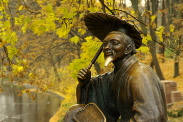 bronze sculpture of a Chinese emperor in the background of the a