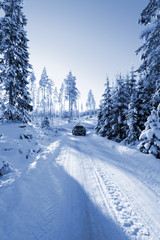 car, suv, driving on snowy country-road