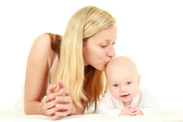 Obraz na płótnie Canvas Young mother kissing baby