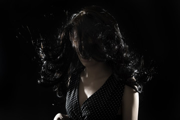 Portrait of a young brunette over black