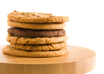 stack of different types of cookies on wooden surface