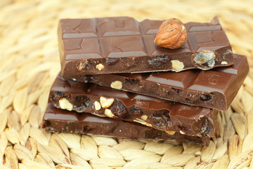 bar of chocolate and nuts on a wicker mat