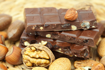bar of chocolate and nuts on a wicker mat