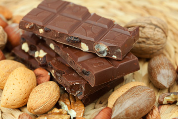 bar of chocolate and nuts on a wicker mat