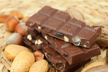 bar of chocolate and nuts on a wicker mat