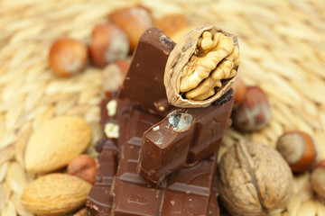 bar of chocolate and nuts on a wicker mat