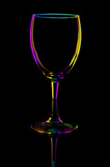 transparent colored empty wine glass on black