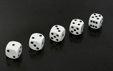 Dices in a row over black