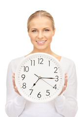 woman holding big clock