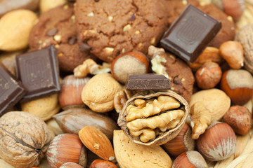 oatmeal cookies, chocolate and nuts on a wicker mat