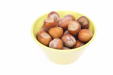 hazelnuts in a bowl isolated on white