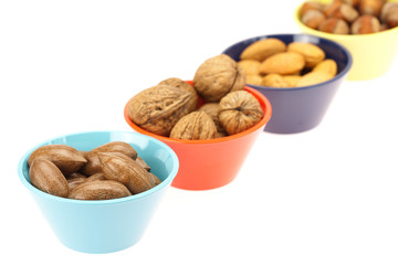 nuts in bowls isolated on white
