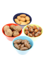 nuts in bowls isolated on white
