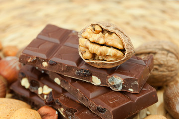 bar of chocolate and nuts on a wicker mat