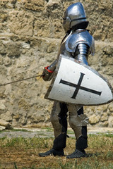 Medieval european knight near citadel wall