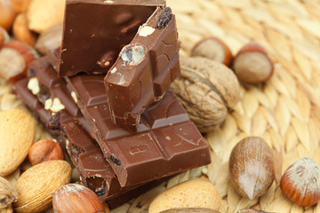 bar of chocolate and nuts on a wicker mat