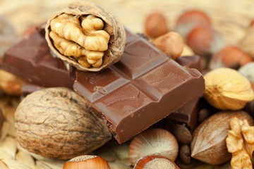 bar of chocolate and nuts on a wicker mat