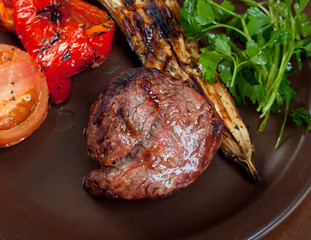 Grilled beef on white plate  with vegetable.