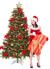 Girl in santa giving gift box by christmas tree.