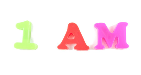 1 am written in fridge magnets on white background