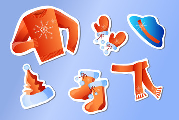 stickers winter holiday clothes on a blue background