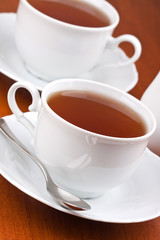 Two cups of tea with saucers