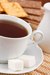 Breakfast: a cup of tea with a lump sugar and crackers