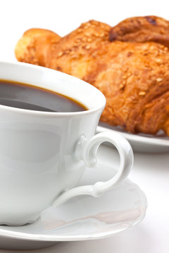 Breakfast: coffee and croissant with sesame seeds