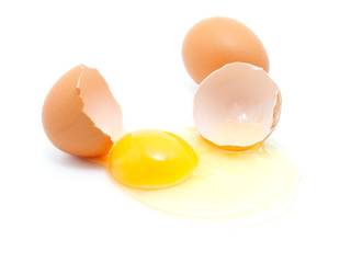brown eggs on a white background. One egg is broken.