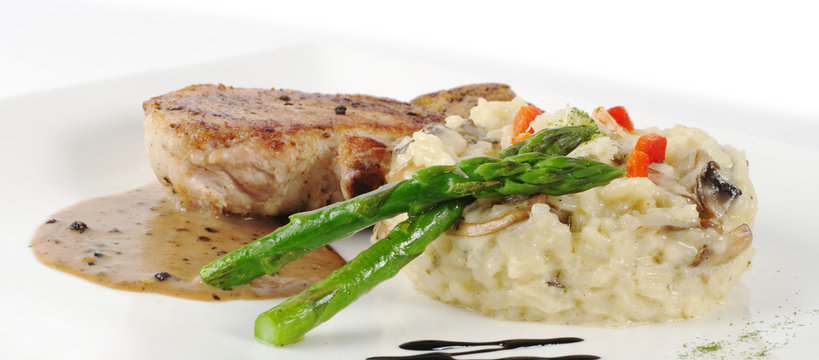 Risotto, green asparagus and meat with gravy