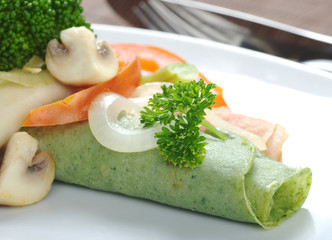 Rolled thin green colored pancake