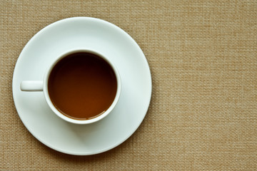 Whie coffee cup on cloth texture