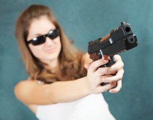 girl aiming a black gun