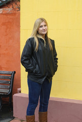 Woman in leather jacket on yellow background