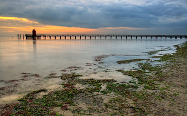 Wooden pier and lighthouse in Lignano Sabbiadoro Italy