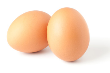 Two brown eggs isolated on white background