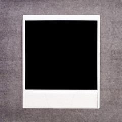 Blank instant photo frame on a cardboard background