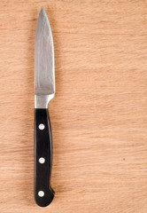 Knife on a wooden background