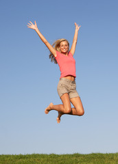 Fototapeta na wymiar Young woman jumping in air
