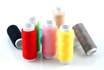 Set of colorful spools of thread isolated on white background