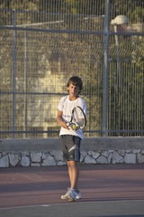 Boy plays tennis