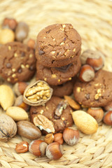 oatmeal cookies, chocolate and nuts on a wicker mat