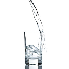 Water poured in a glass against white background