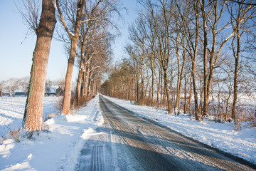 Slippery road in frozen Dutch farmland