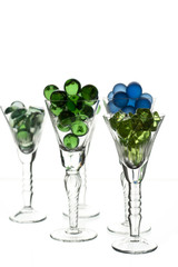different glasses full with marbles