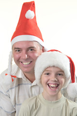 Father and son is in the caps of Santa claus